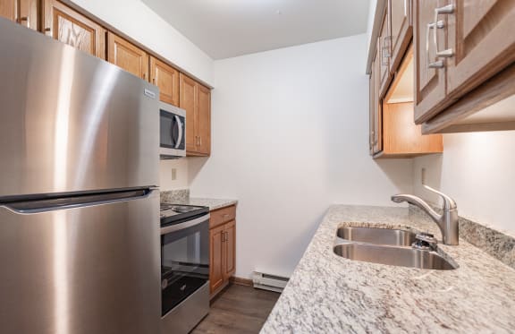 a kitchen with stainless steel appliances and granite counter tops