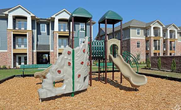 a playground with a play set in front of houses