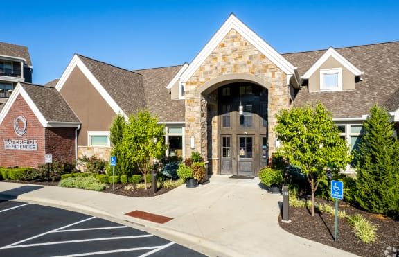 the front of a house with a driveway and a parking lot  at Waterside Residences on Quivira, Lenexa