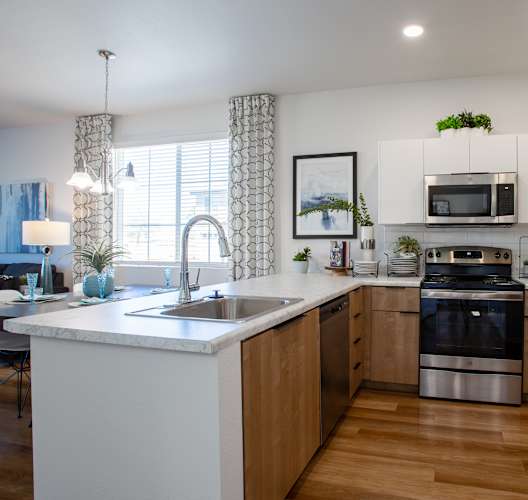 a kitchen with wooden cabinets and stainless steel appliances