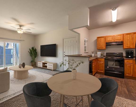 A modern living room with a flat screen TV, a kitchen area, and a dining table.