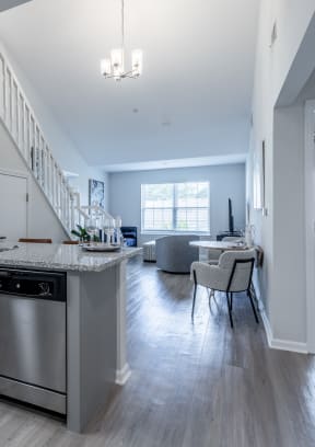 an open kitchen and living room with a staircase