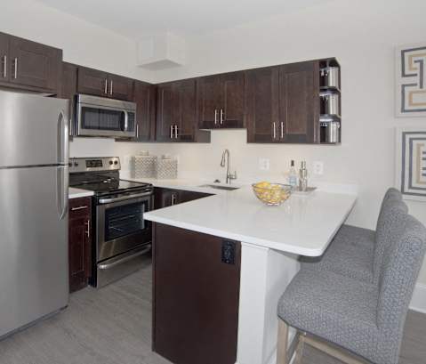 a kitchen with stainless steel appliances and a white counter top