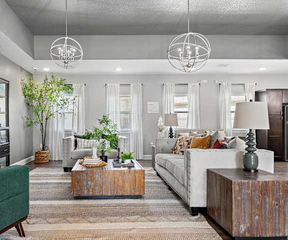 A living room with a green couch, wooden coffee table, and a white sofa.