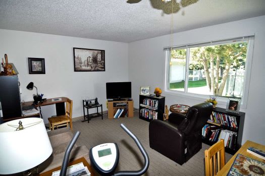 a living room filled with furniture and a flat screen tv