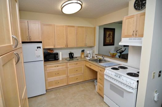 a kitchen with a white stove top oven next to a refrigerator