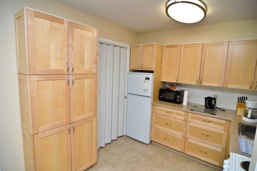 a kitchen with wooden cabinets and a white refrigerator