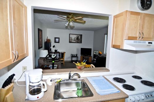 a kitchen sink sitting next to a stove top oven