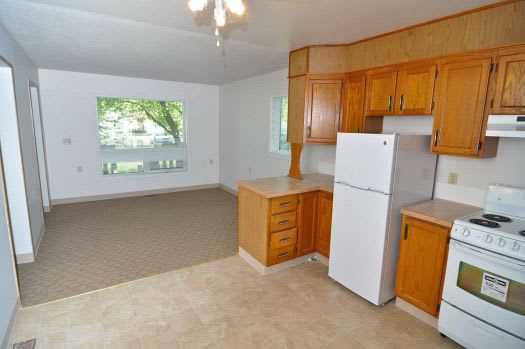 a kitchen with a stove a refrigerator and a window