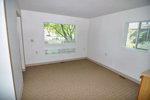 an empty room with a large window and a door