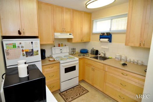 a kitchen with a white stove top oven next to a refrigerator
