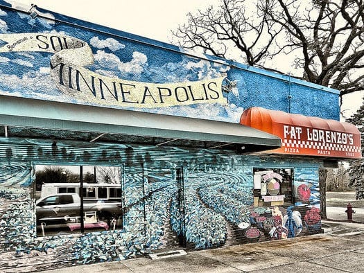 a store with a mural on the side of it