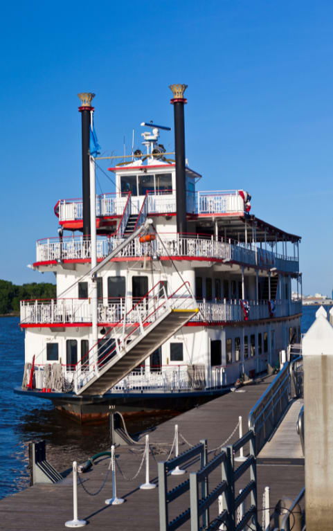 a ferry on the water with a dock in the foreground