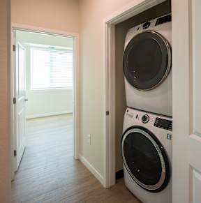 A white washing machine is in a doorway.