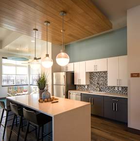 A kitchen with a wooden ceiling and a white counter.