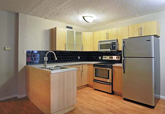 a kitchen with stainless steel appliances and wooden cabinets