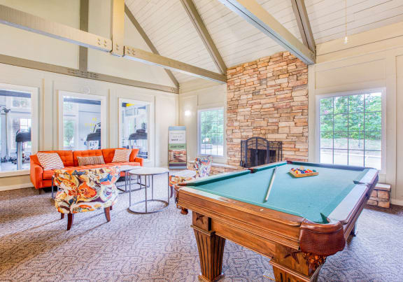 a game room with a pool table and a fireplace at The Grove Brentwood in Nashville, TN