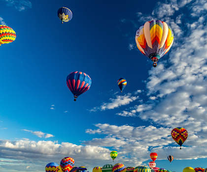a group of hot air balloons flying in the sky