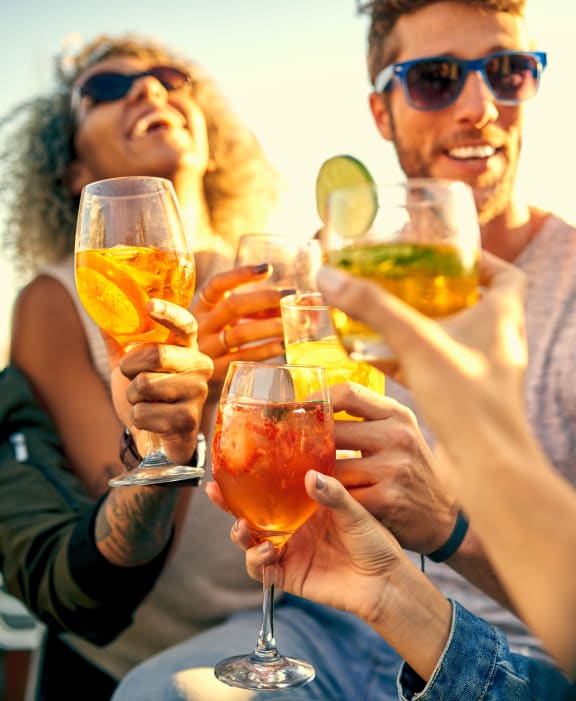a group of friends drinking wine on the beach