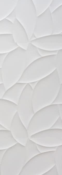 a close up of a white flowery design on a wall