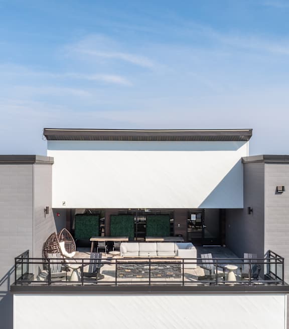 A modern house with a balcony and a white awning.