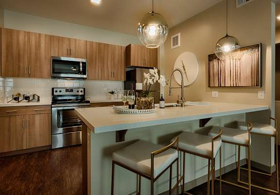 a kitchen with an island and three stools