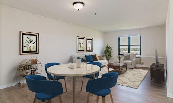 A living room with a white table and blue chairs at Branchwood Towers, Clinton, MD, 20735