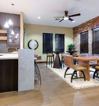 A kitchen with a dining table and chairs.
