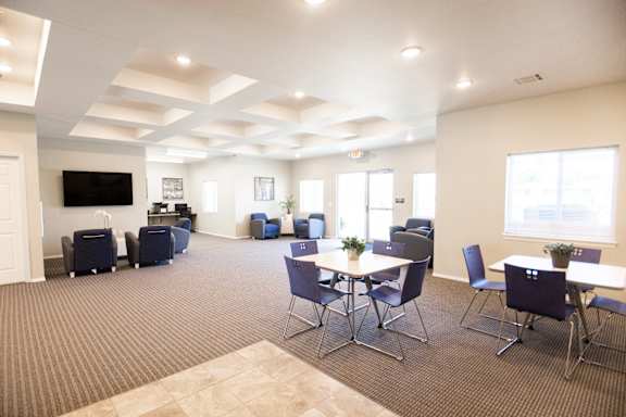 A conference room with a long table and chairs.
