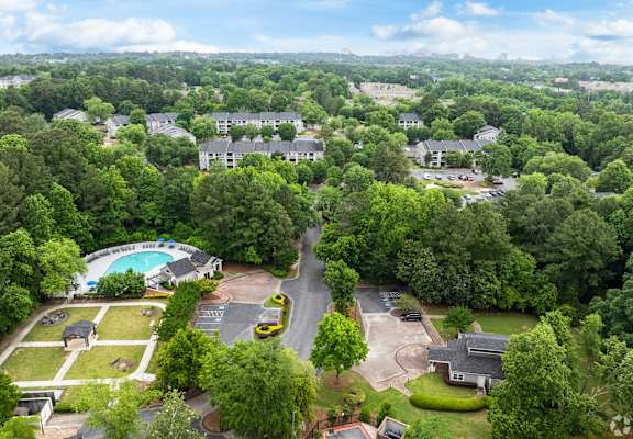 an aerial view of a neighborhood with houses and a swimming pool