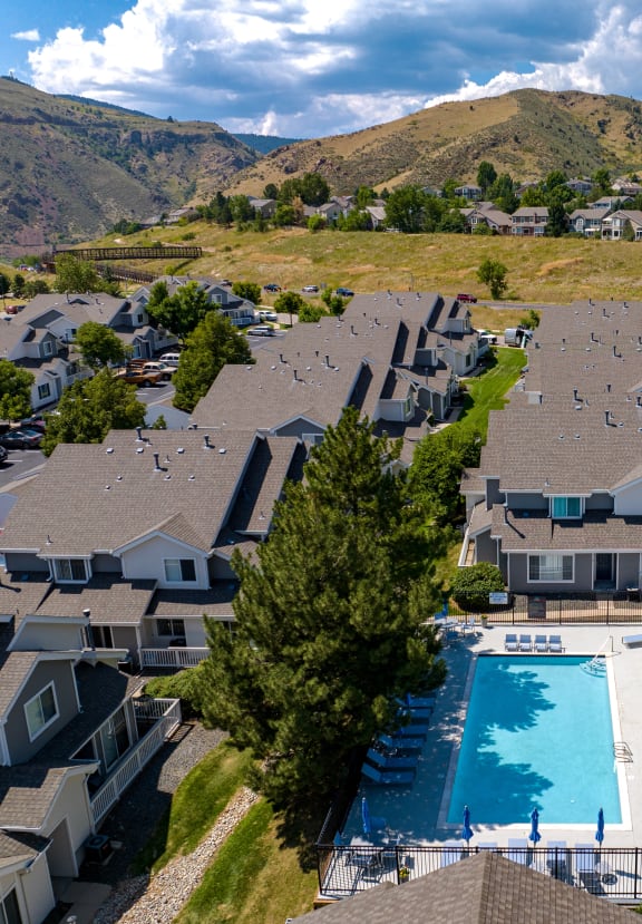 an aerial view of houses and a swimming pool in a valley