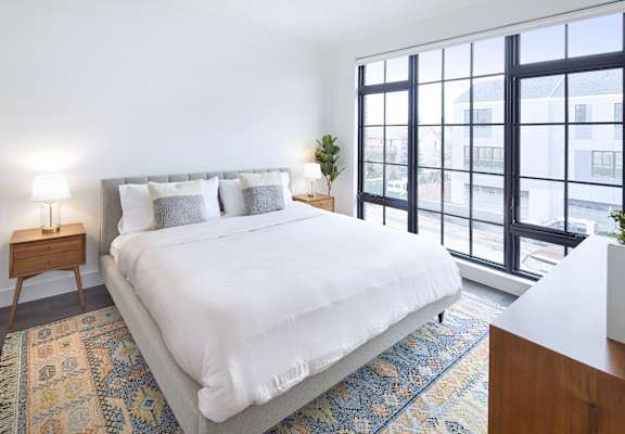 a bedroom with a large bed and a window