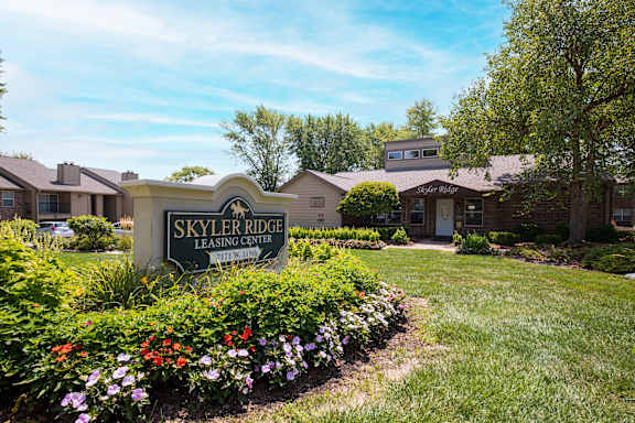 The Skyler Ridge Clubhouse, set against lush greenery and a scenic outdoor space for residents to enjoy.