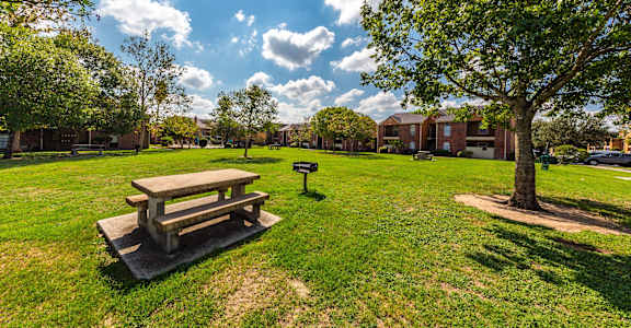 a park with a picnic table and a tree at Oaks of Westlakes Apartments, San Antonio, 78245