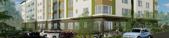 A modern apartment building with cars parked in front.