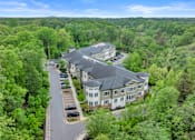 Thumbnail 41 of 54 - A bird's eye view of a large building surrounded by trees.