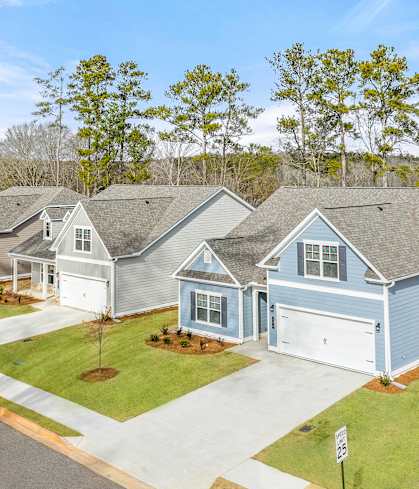 a row of blue and white houses on the side of a street