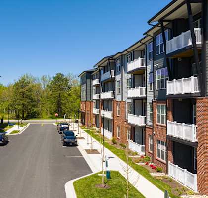 A street view of a residential area with apartment buildings on both sides.
