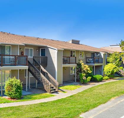 A sunny day at a residential building with a clear blue sky.