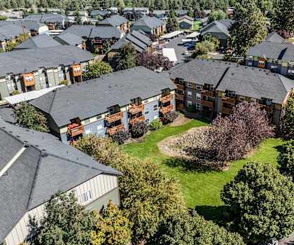 an aerial view of a neighborhood with houses and green grass
