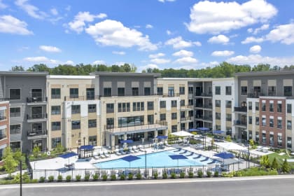 an aerial view of an apartment building with a swimming pool