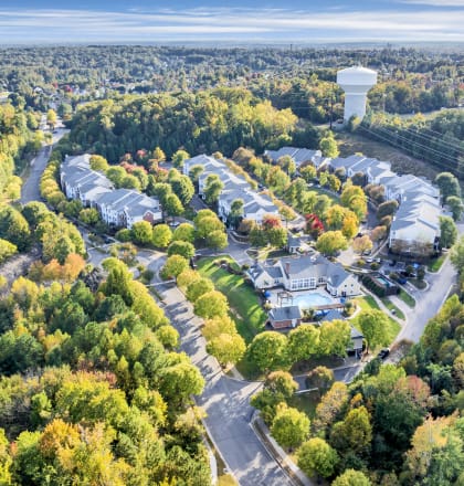 an aerial view of a neighborhood with trees and a water tower