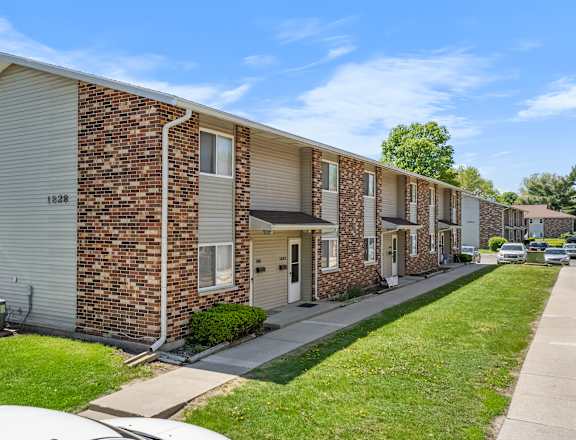 A row of brick apartment buildings with garage doors.