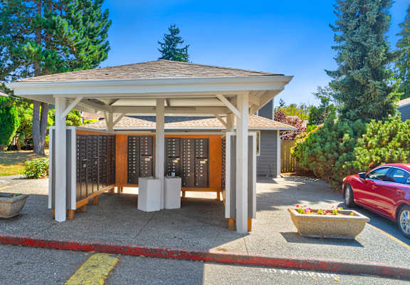 A covered patio area with a table and chairs is surrounded by a red and white striped tape.