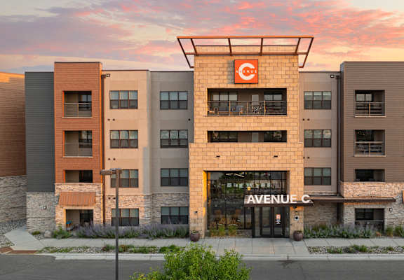 an exterior view of anaweel cc building at sunset at Avenue C Apartments, Billings, MT, 59102