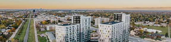 an aerial view of three high rise buildings in a city