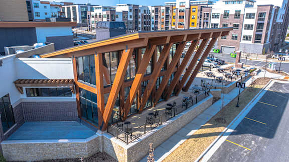 A modern building with a wooden structure on the roof.
