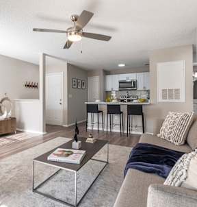 A modern living room with a grey couch and a brown chair.