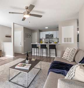 A modern living room with a grey couch and a brown chair.