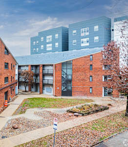 A red brick building with a white building next to it.